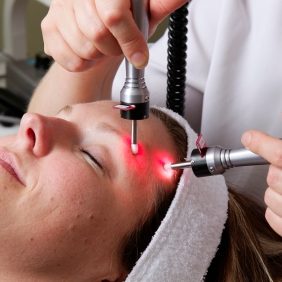 Patient receiving Light Therapy treatment from a Holistic Esthetician